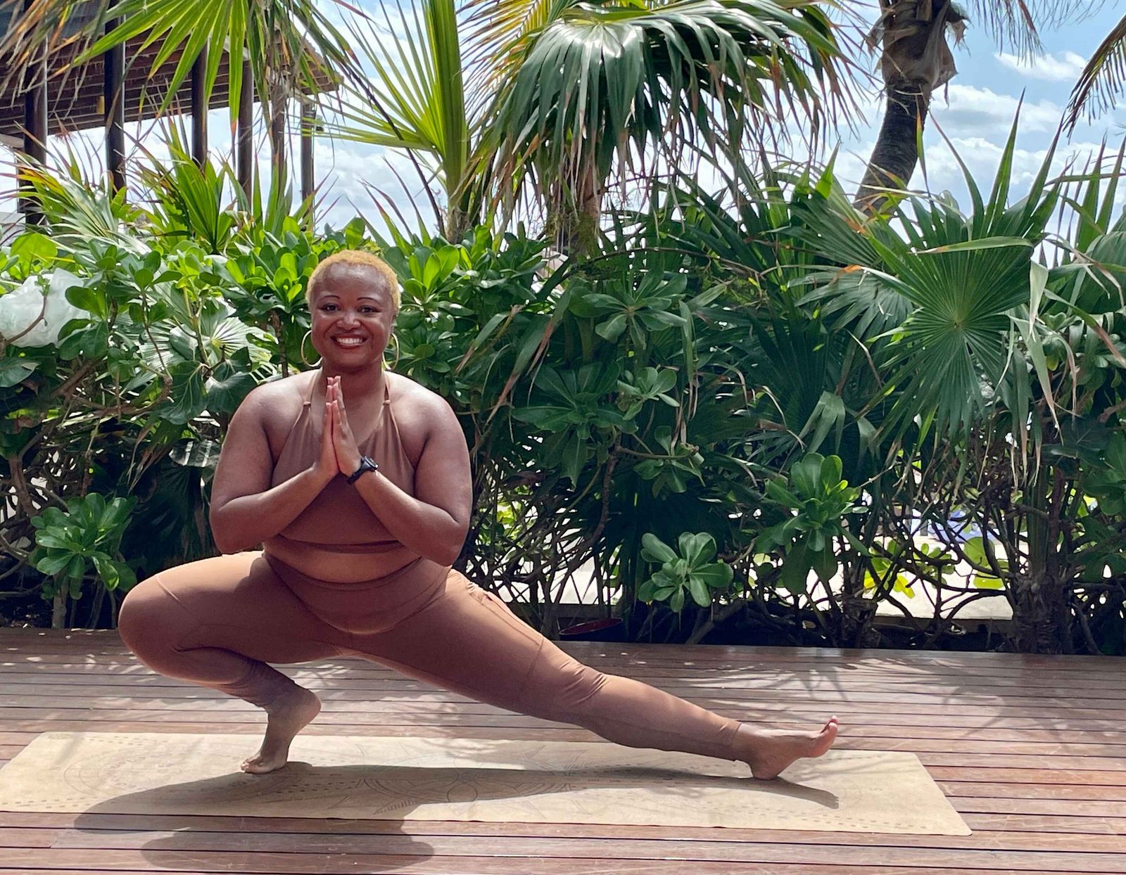 Woods in a yoga lunge in a lush tropical setting